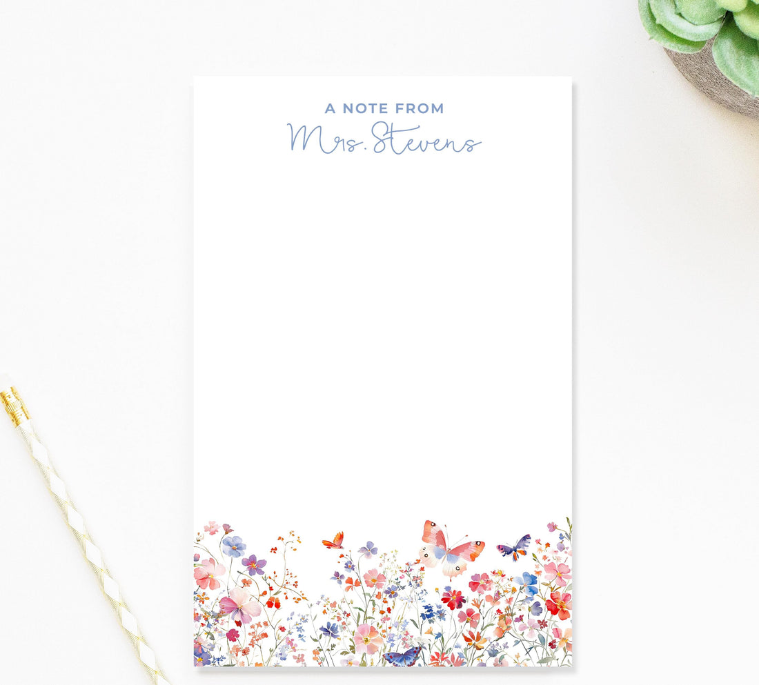 a blank note pad with a floral design on the bottom half and a note from "Mrs. Stevens" on the top half.