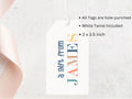 A white gift tag with text and a ribbon.