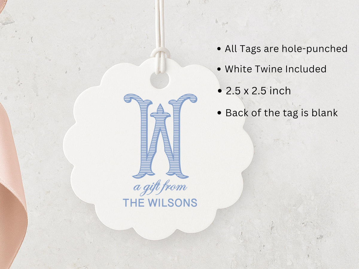 A white tag with a blue monogram, hanging on a string.