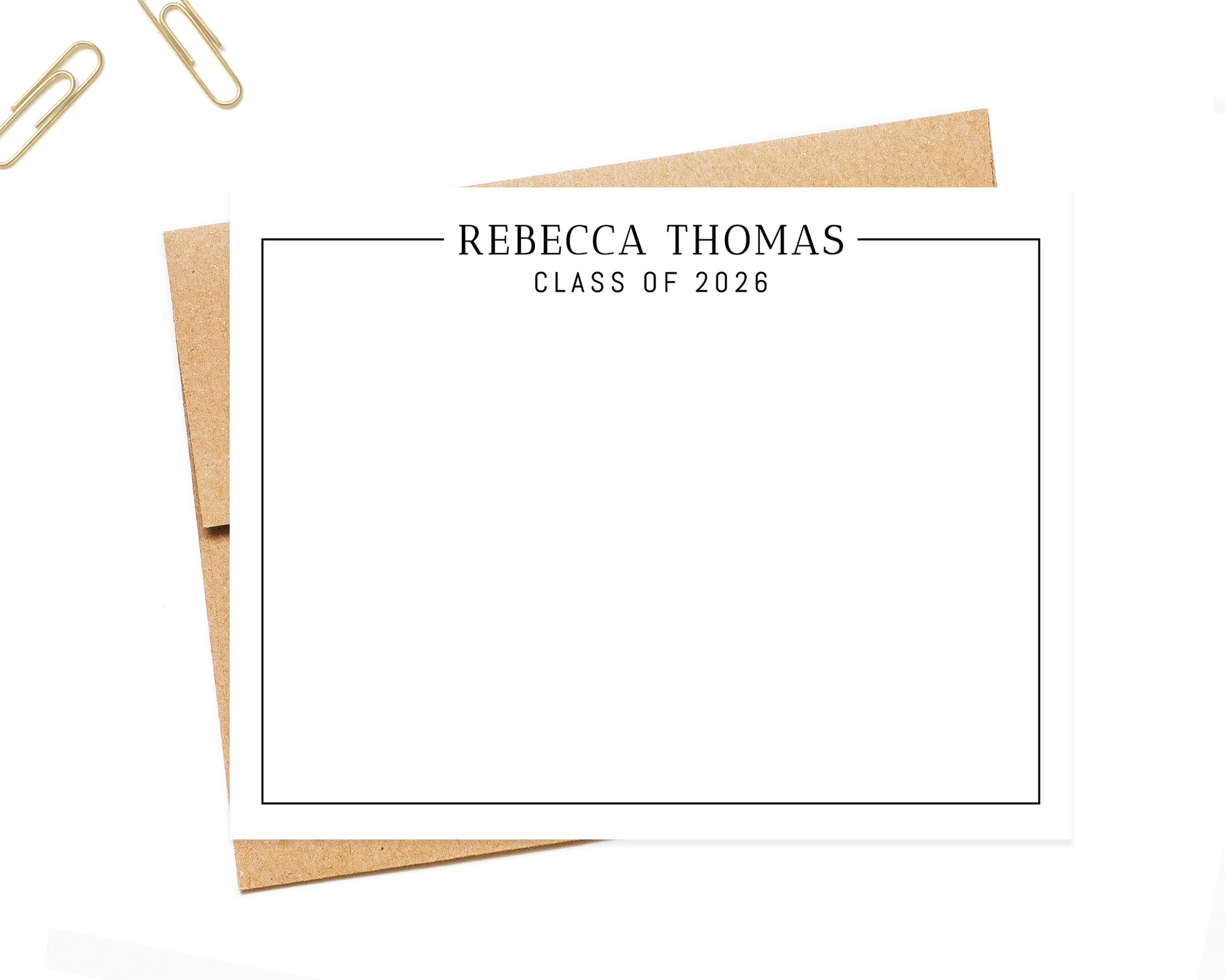 a blank card with the name "Recca Thomas" and the year "CLASS OF 2026" printed on it, along with a few office supplies such as a stapler and a pair of scissors.