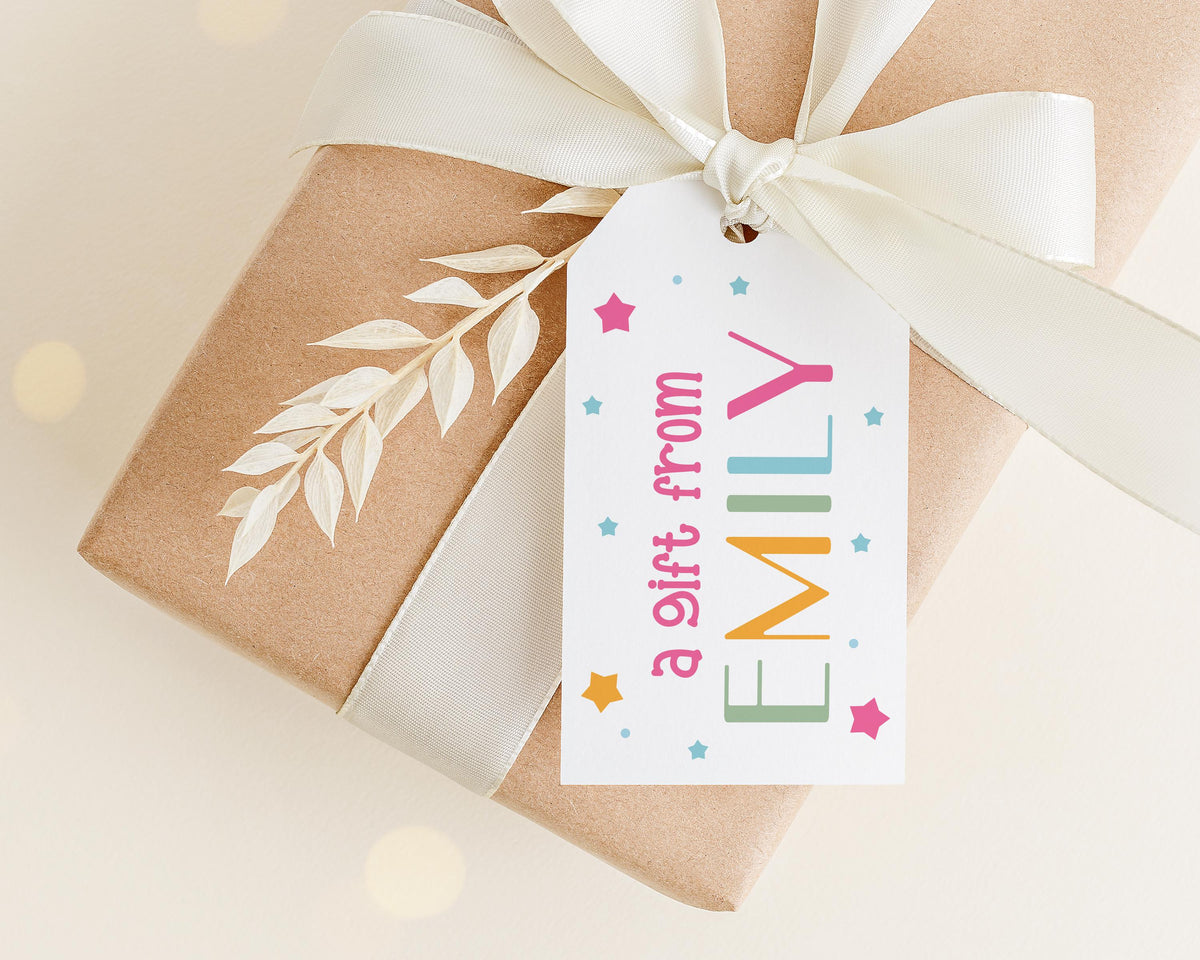 A gift wrapped in brown paper with a white ribbon and a tag that reads "a gift from Emily" with colorful stars and a leaf design.