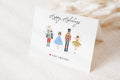 A greeting card featuring four illustrated characters in costumes, including a nutcracker, a mouse, a ballerina, and a fairy. The card has a 