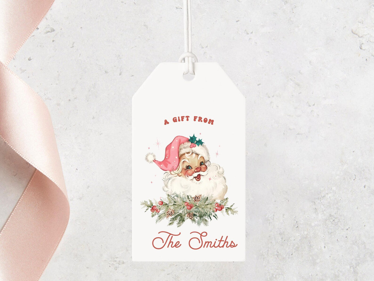 A white gift tag with a Santa Claus illustration and the text "A GIFT FROM The Smiths" hanging on a string.