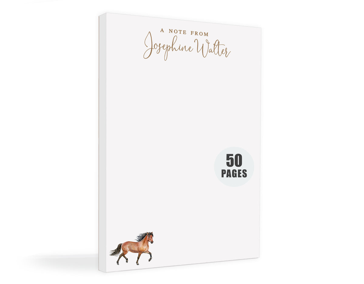 a white notepad with a horse illustration on the cover.