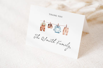 A white card with a gratitude message and illustrations of clothes hanging on a clothesline.