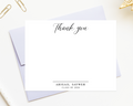 a blank thank you card with a personalized message, placed on a white surface alongside some office supplies.