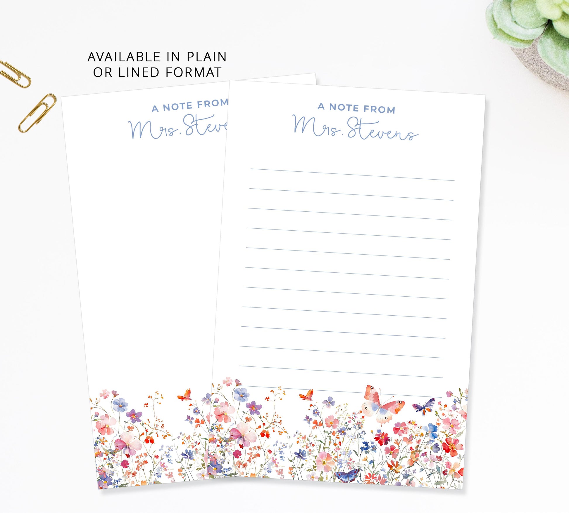 two blank note pads with a floral border, placed on a white surface.