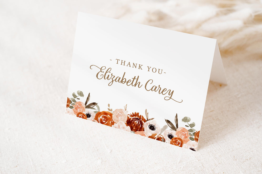 A white card with a floral design and text on it.